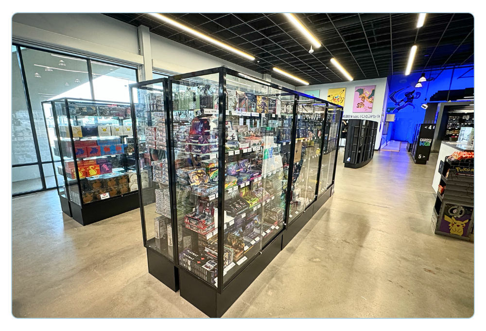 Professional trading card store layout using showcases, wall displays and retail shelving
